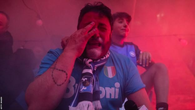 A Napoli fan cries with joy after his team win Serie A