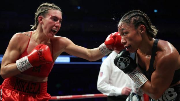 A photo of former world champion Mikaela Mayer throwing a jab during her fight with Alycia Baumgardner in October