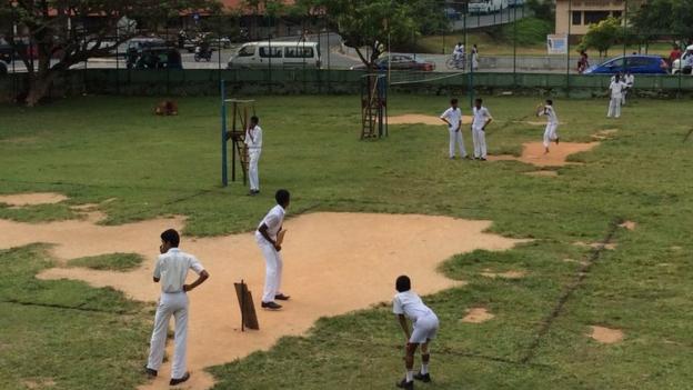 Children playing cricket in Galle