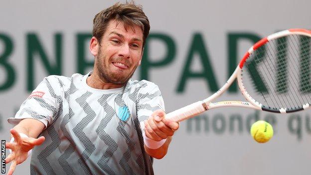 Cameron Norrie hits a return against Rafael Nadal