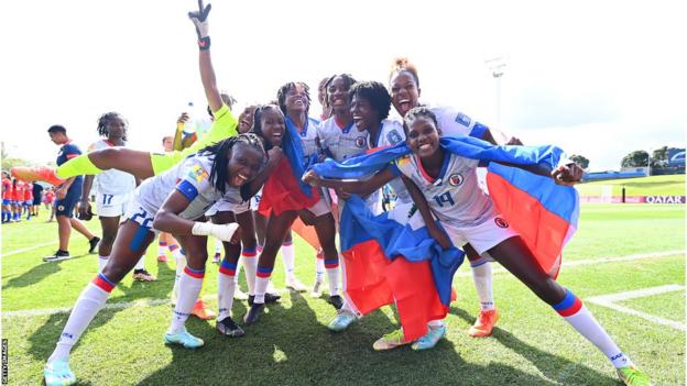 Haitian players celebrate their qualifying win over Chile