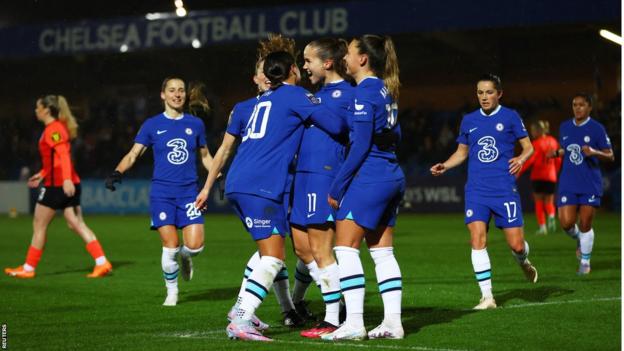 Chelsea players celebrate scoring a goal against Brighton in the Women's Super League