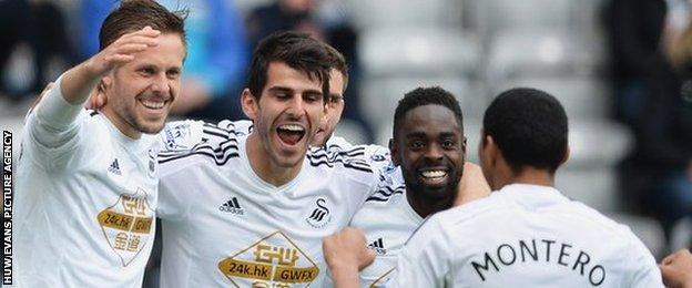 Gylfi Sigurdsson, Nelson Oliveira and Nathan Dyer celebrate a goal in the away win against Newcastle United with Jefferson Montero