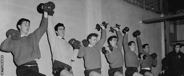 Spurs players train with weights in the gym before facing Newport in the FA Cup in January, 1960