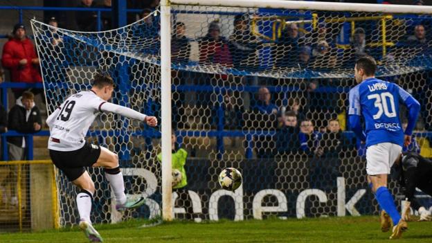 Glentoran's David Fisher takes a shot on goal at Morneview Park in the first half.