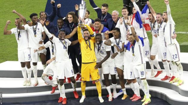 France players celebrate with the Nations League trophy on the podium after beating Spain in the 2021 final