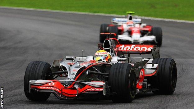 Lewis Hamilton passes Timo Glock on the final corner of the Brazilian Grand Prix