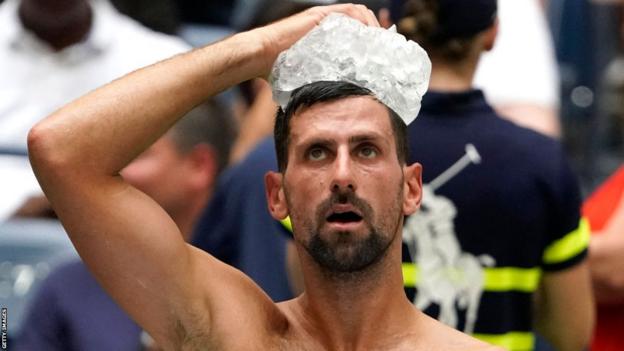 Novak Djokovic holds an ice pack on his head