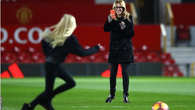 Actress Julia Roberts takes photos on the Old Trafford pitch after the Premier League match between Manchester United and West Ham United in 2016