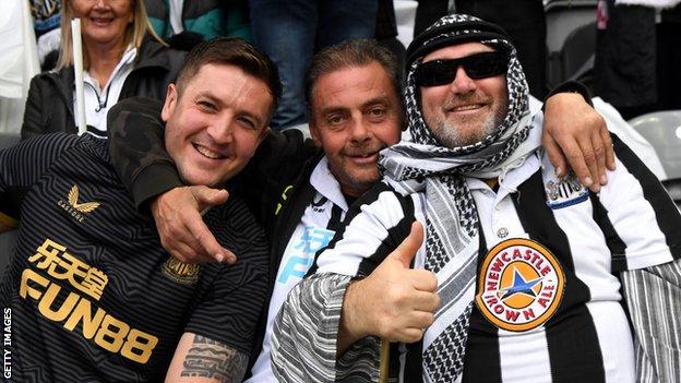 Newcastle fans celebrate the club's new era under new owners