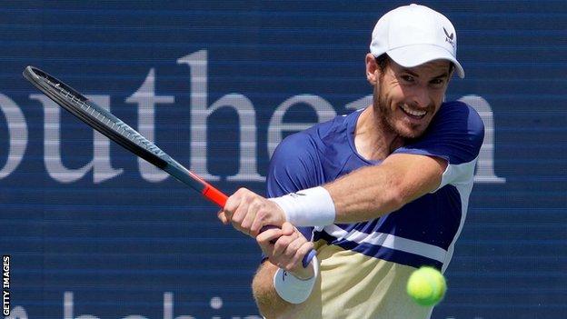 Andy Murray hits a return against Stan Wawrinka in their Western and Southern Open first-round match
