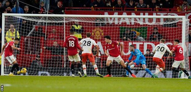 Manchester United defender Harry Maguire blocks Jarrod Bowen's shot