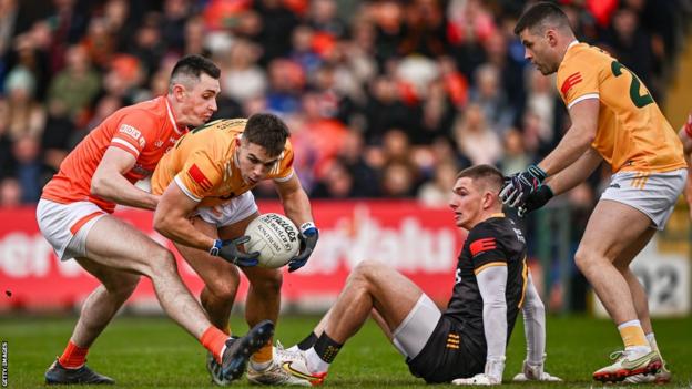 Armagh's Shane McPartlan challenges Antrim's Eoghan McCabe