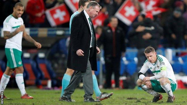 Michael O'Neill walks over to console Steven Davis after Northern Ireland failed to make it to the World Cup finals