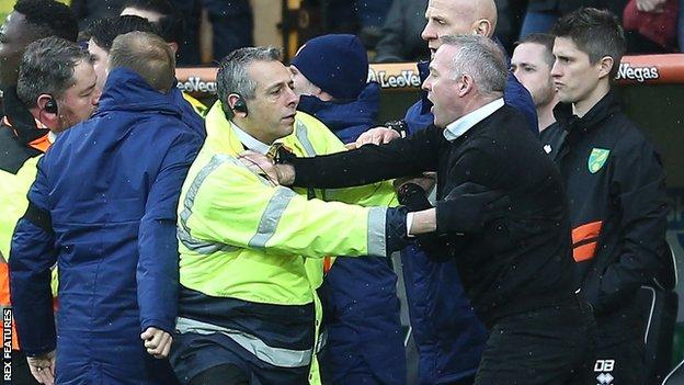 Ipswich manager Paul Lambert is calmed down by a steward