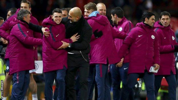 Manchester City players and staff celebrate their derby win at Old Trafford