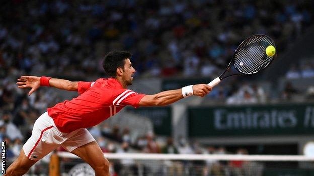 Novak Djokovic stretches for a return against Matteo Berrettini in their 2021 French Open quartar-final