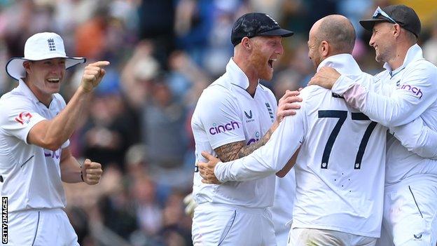 Jack Leach celebrates a wicket with Ben Stokes and Joe Root