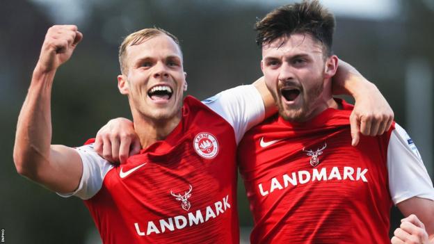 Leroy Millar celebrates Larne's second goal against Glentoran with scorer Lee Bonis