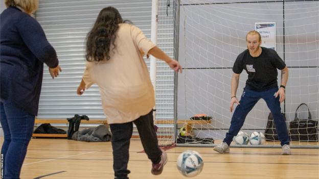 Paralympic champion Jonnie Peacock saves a shot at the Every Body Moves launch