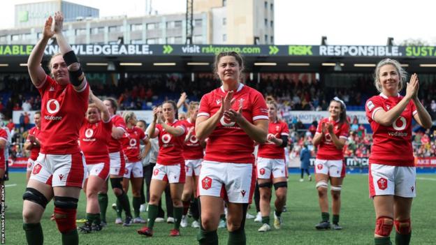 Abbie Fleming, Robyn Wilkins and Elinor Snowsill clap the crowd at Cardiff Arms Park