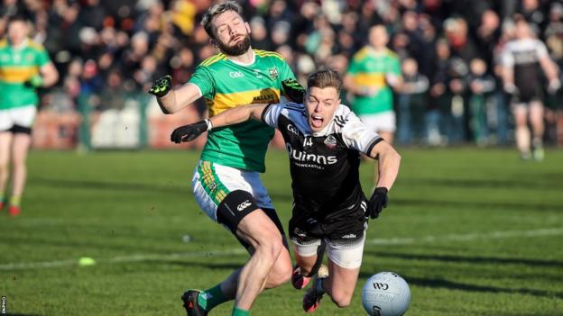 Glen full-back Ryan Dougan battles with Kilcoo's Jerome Johnston