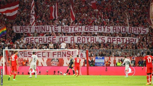 Bayern Munich fans holding banners asking authorities to 'respect fans' after UK games were postponed because of the death of Queen Elizabeth II