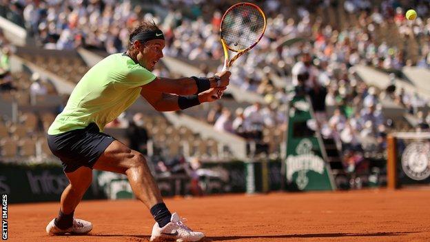 Rafael Nadal returns in a game against Diego Schwartzman at the French Open