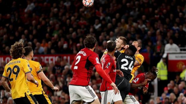 Man Utd goalkeeper Andre Onana appears to foul two Wolves players