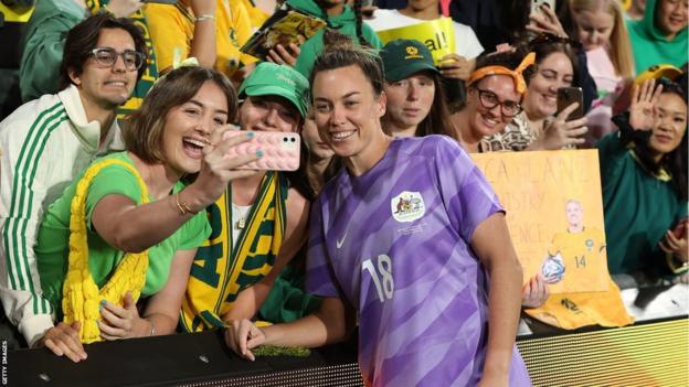 Mackenzie Arnold poses for a photo with Australian fans