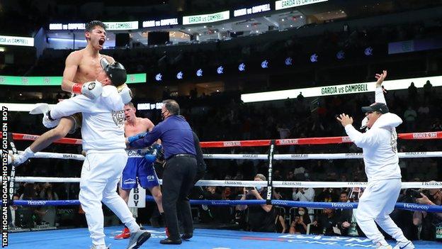 Ryan Garcia is lifted by one of his team after beating Luke Campbell