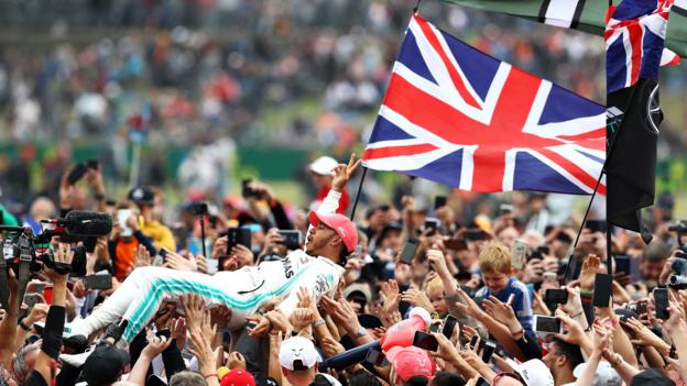 14th July 2019; Silverstone Circuit, Northampton, England; FIA F1 Grand Prix of Britain, Race Day; Mercedes AMG Petronas Motorsport driver Lewis Hamilton celebrates his win with the fans (photo by Tim Williams/Action Plus via Getty Images)