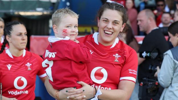 Natalia John holds her nephew Morgan in her arms before Wales played England in the 2023 Six Nations