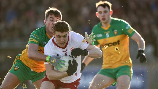 Donegal's Martin O'Reilly is tackled by Peter Harte of Tyrone
