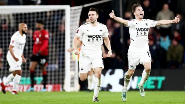 Boreham Wood's players celebrate after beating Bournemouth in the FA Cup