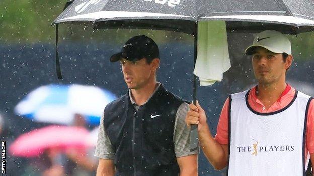 Rory McIlroy and caddie Harry Diamond in the rain at TPC Sawgrass