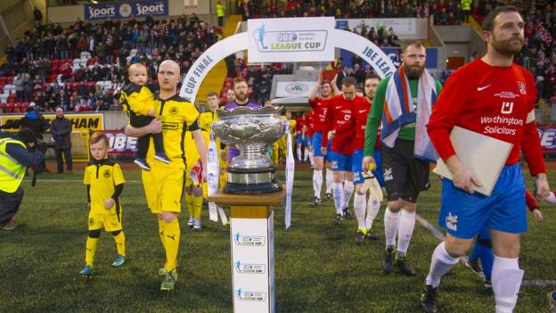 Cliftonville and Ards come onto the pitch prior to the kick-off at Solitude