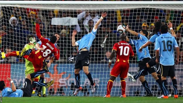 Luis Suarez handles a goal-bound effort in the World Cup quarter-final between Ghana and Uruguay in 2010