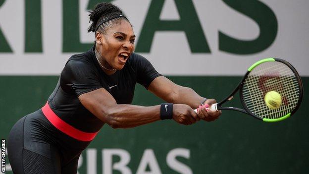 Serena Williams plays a backhand while wearing a black catsuit at the French Open