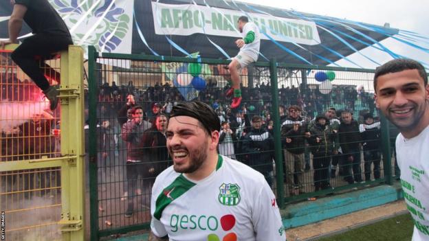 Diego Maradona Jr celebrates with the fans and players of Afro Napoli United