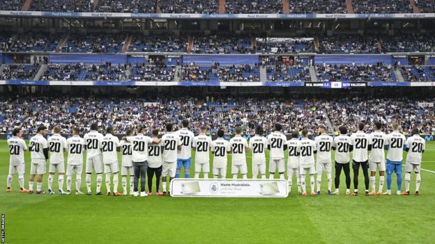 Real Madrid players wear shirts saying 'Vini Jr 20' ahead of their La Liga game against Rayo Vallecano