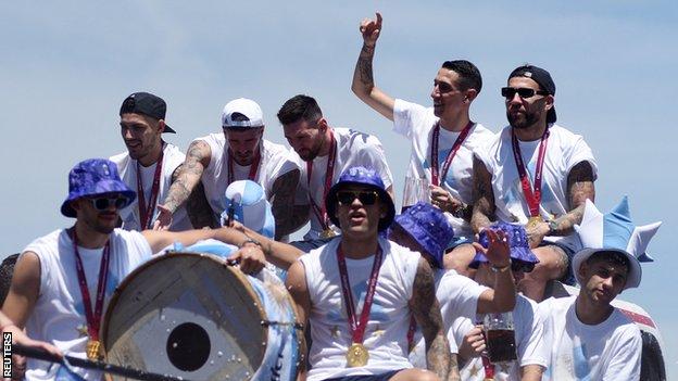 Argentina players - including captain Lionel Messi - celebrate with their adoring fans from an open-top bus during Tuesday's parade