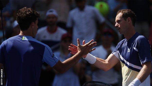 Francisco Cerundolo and Andy Murray shake hands at the net after their 2022 US Open match