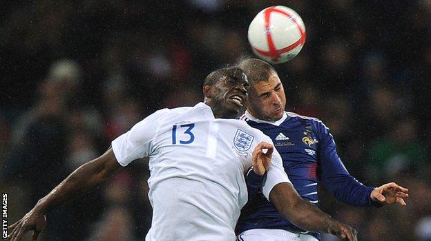 Micah Richards challenges France's Karim Benzema
