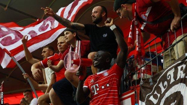Sadio Mane celebrates with Bayern Munich fans after the team beats Eintracht Frankfurt on his Bundesliga debut