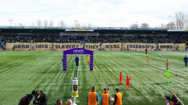 Celtic fans display a banner before kick-off