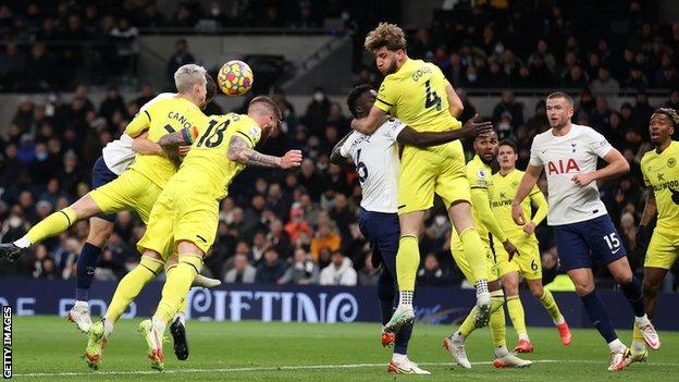 Brentford's Sergi Canos scores an own goal against Tottenham in the Premier League