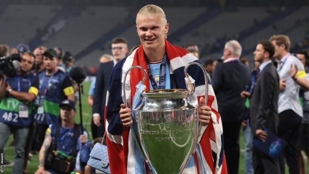 Erling Haaland poses with the Champions League trophy after Manchester City's Champions League final victory over Inter Milan
