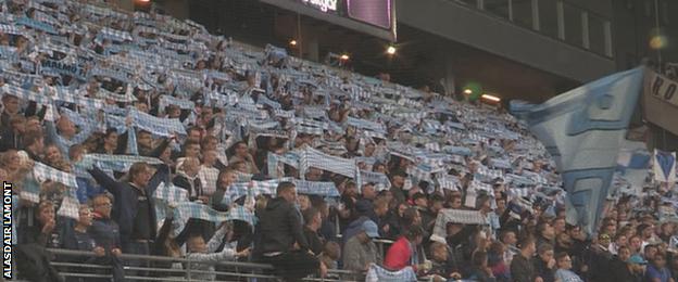 Malmo fans hold up flags in unison