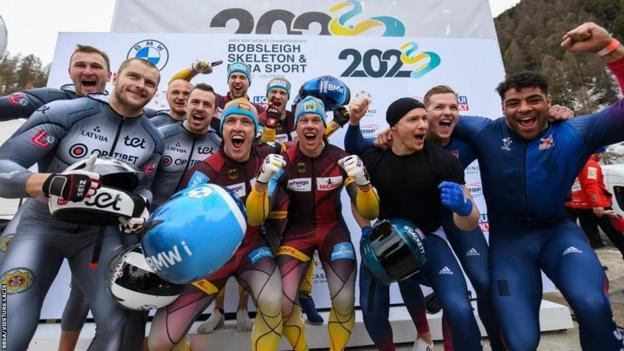 Britain's four-man bobsleigh team, right, celebrate with fellow medallists after finishing second at the World Championships in St Moritz, Switzerland